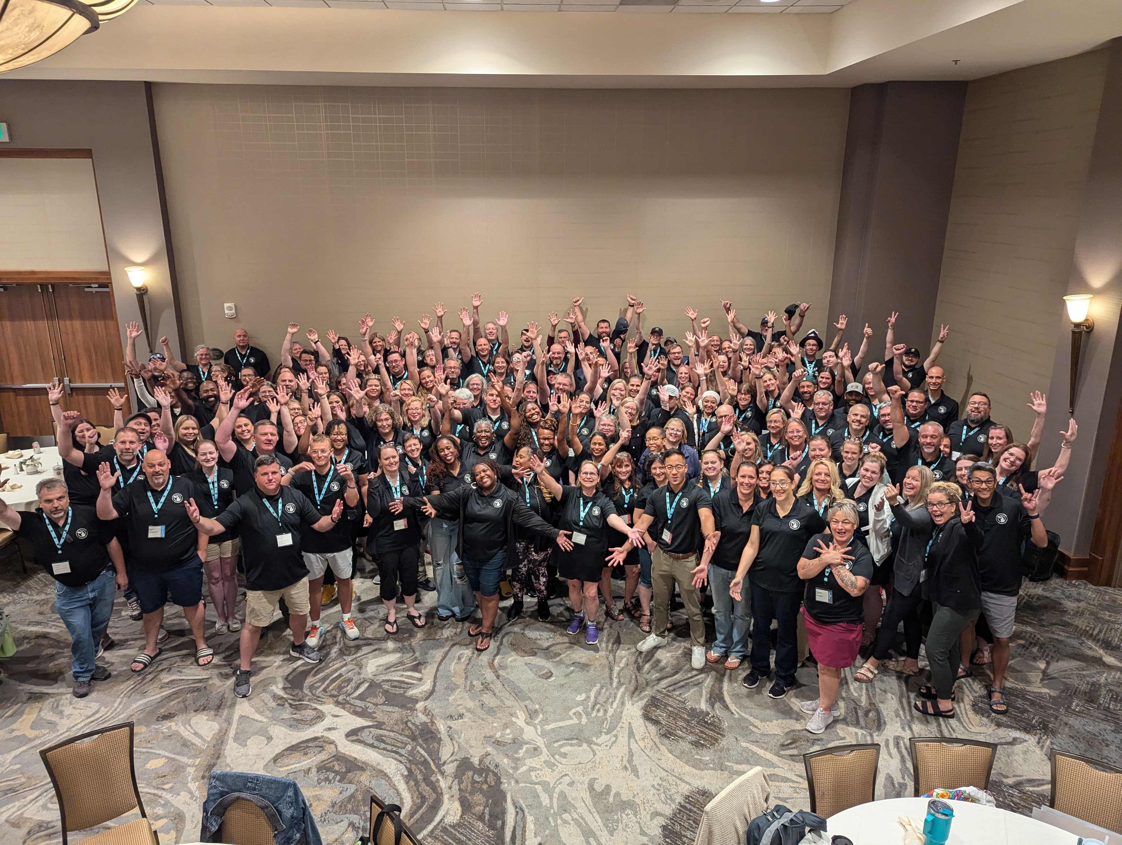 TeacherCon 2024 Photo - Educators with hands in the air celebrating